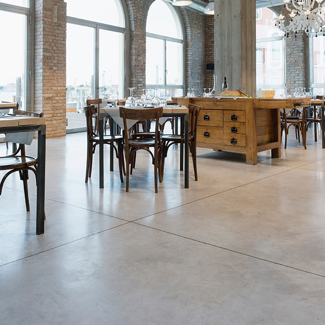 Sol béton ciré lissé dans une salle de restaurant
