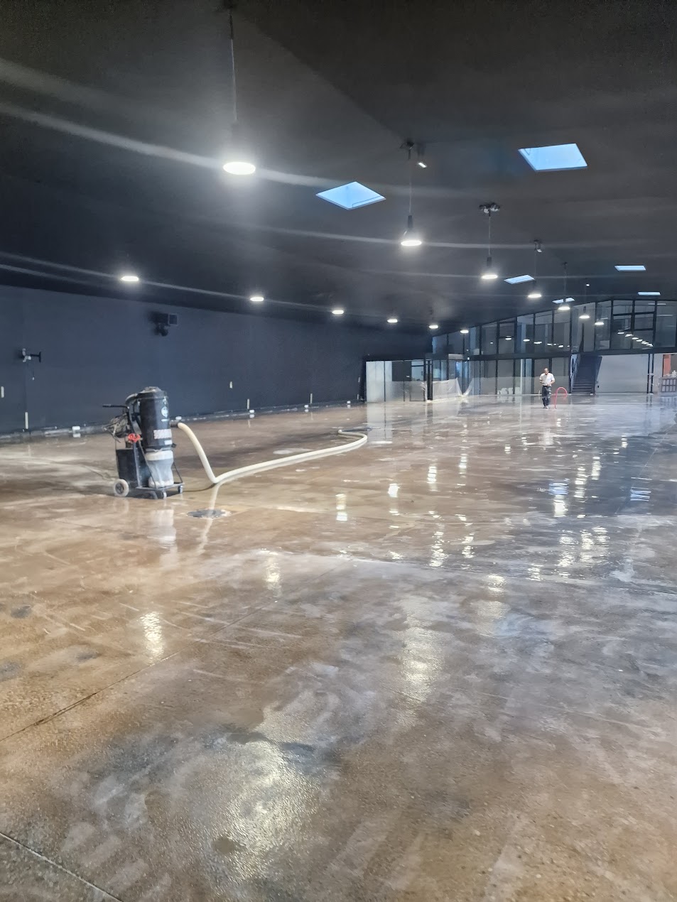 Sol résine coulé dans un bâtiment industriel, surface continue et réfléchissante